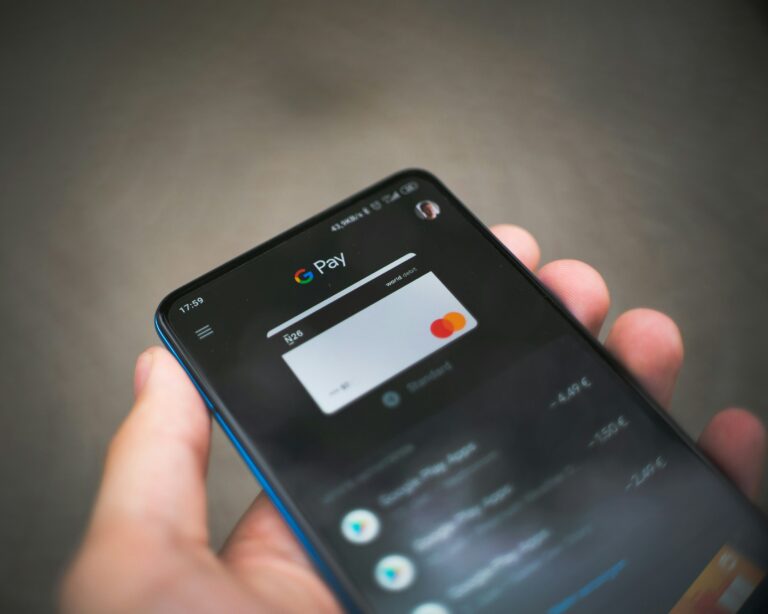 a hand holding a cell phone
